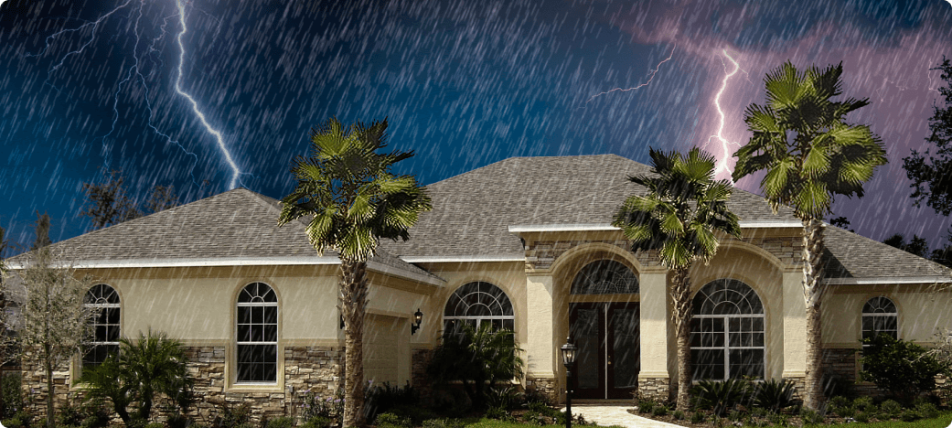 Florida stucco home with palm trees during a lightning storm